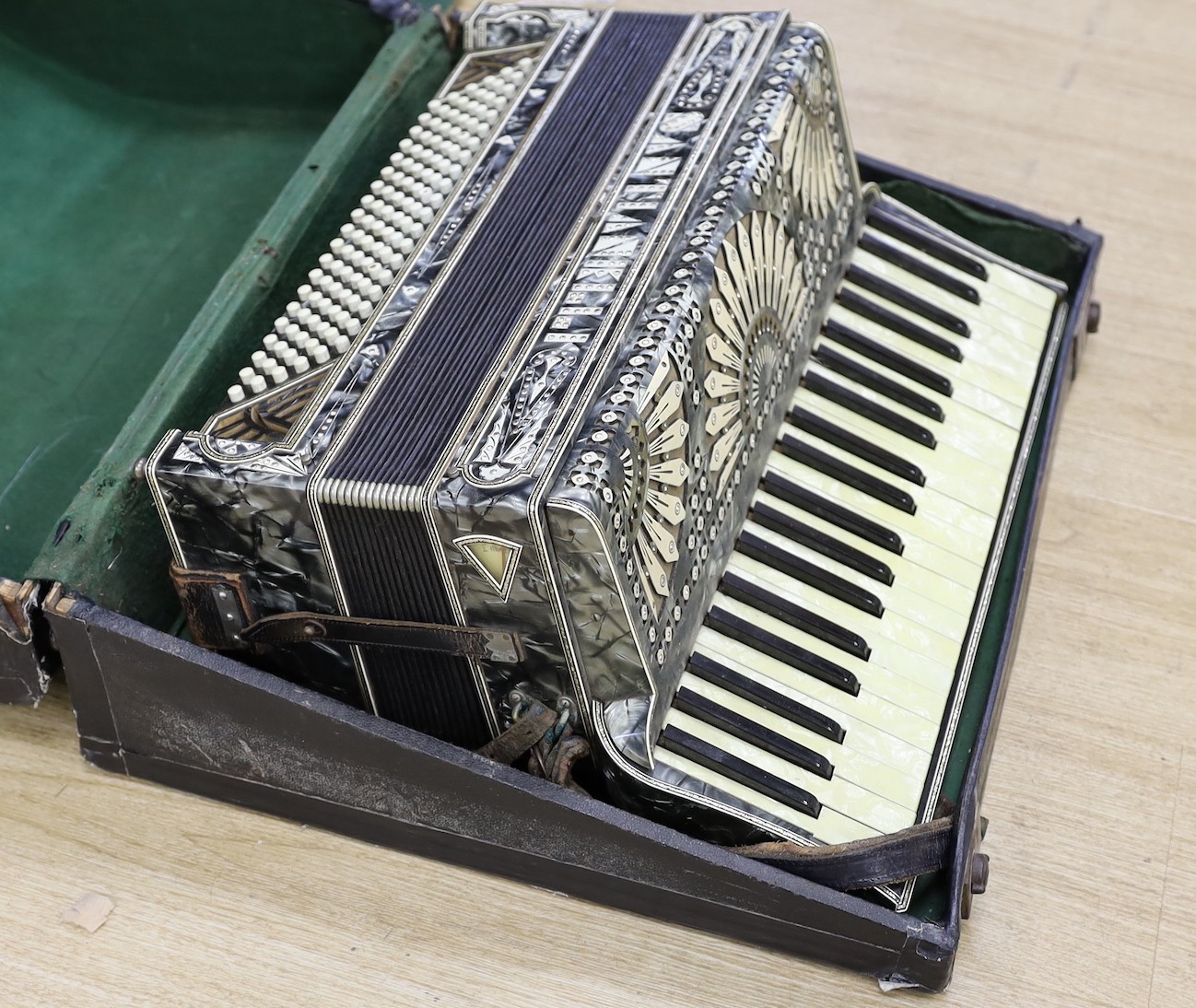 A cased Santiarelli cased accordion, 51 cms wide